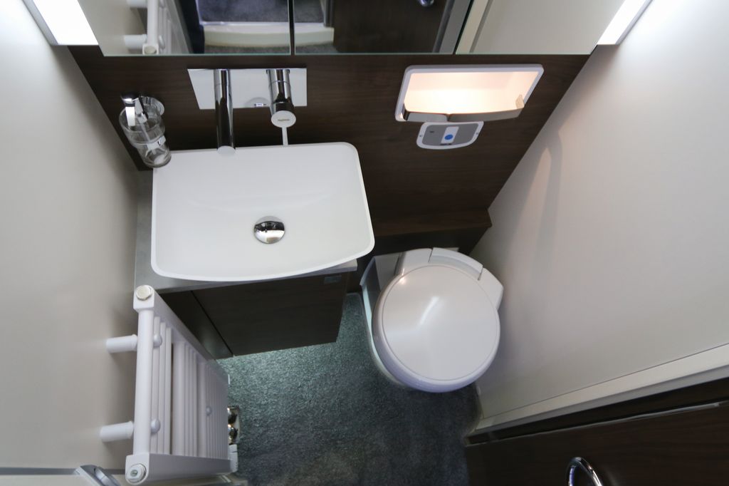 Toilette con lavandino a vasca sollevata e WC rivestito in ceramica